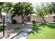 Charming single-story home featuring mature trees, a stone path, and a well-maintained lawn at 2459 S Xanadu Way # B, Aurora, CO 80014