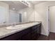 Bathroom featuring a double sink vanity with modern fixtures and a tub with shower at 1456 Sepia Ave, Longmont, CO 80501