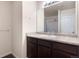 This bathroom showcases a vanity with storage space, and a neutral countertop and mirror at 1456 Sepia Ave, Longmont, CO 80501