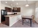 Open kitchen featuring dark cabinets, black appliances, and an adjacent dining area at 1456 Sepia Ave, Longmont, CO 80501