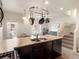 Functional kitchen with a double sink, dark wood cabinets, and open layout design at 1456 Sepia Ave, Longmont, CO 80501