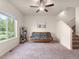 Spacious living area featuring natural light, comfortable seating, and staircase access at 1456 Sepia Ave, Longmont, CO 80501