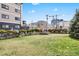 Spacious backyard with healthy lawn, perimeter landscaping, and wrought iron fence at 350 Detroit St # 107, Denver, CO 80206