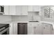 A modern kitchen features white cabinets, stainless steel appliances, and a sink with a countertop perfect for meal prep at 350 Detroit St # 107, Denver, CO 80206