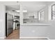 A modern kitchen features white cabinets, stainless steel appliances, and a sink with a countertop perfect for meal prep at 350 Detroit St # 107, Denver, CO 80206