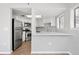 Bright kitchen with stainless steel appliances, white cabinets, and stone countertops at 350 Detroit St # 107, Denver, CO 80206