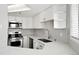 A modern kitchen features white cabinets, stainless steel appliances, and a sink with a countertop perfect for meal prep at 350 Detroit St # 107, Denver, CO 80206