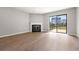Living room features a fireplace and sliding glass door to a balcony at 350 Detroit St # 107, Denver, CO 80206