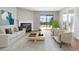 The bright living room features a fireplace, stylish furniture, and a sliding door leading to outdoor green space at 350 Detroit St # 107, Denver, CO 80206