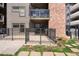 This outdoor patio features a metal fence and brick accents, perfect for enjoying the fresh air and outdoor activities at 350 Detroit St # 107, Denver, CO 80206
