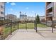 This outdoor patio features a metal fence and brick accents, perfect for enjoying the fresh air and outdoor activities at 350 Detroit St # 107, Denver, CO 80206
