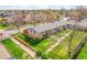 Aerial view of a single-story home with well-manicured landscaping, mature trees, and fenced yard at 4201 Shoshone St, Denver, CO 80211