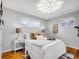 Stylish bedroom features two windows, hardwood floors, and neutral paint at 4201 Shoshone St, Denver, CO 80211