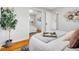 Bright bedroom with hardwood floors offers a mirrored closet and neutral decor at 4201 Shoshone St, Denver, CO 80211