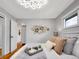 Stylized bedroom boasts hardwood floors, natural light, and neutral decor at 4201 Shoshone St, Denver, CO 80211