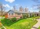Beautiful single-story home with brick and siding, lush lawn, and blue trim at 4201 Shoshone St, Denver, CO 80211