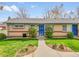 Charming single-story home with brick accents, blue shutters, and a well-maintained lawn at 4201 Shoshone St, Denver, CO 80211