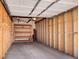 Unfinished two-car garage featuring built-in shelving for convenient storage solutions at 4201 Shoshone St, Denver, CO 80211