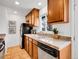 Well-lit kitchen with granite countertops, stainless sink, and dark appliances at 4201 Shoshone St, Denver, CO 80211