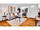 Cozy living space with hardwood floors, a gray couch, and natural light from a nearby window at 4201 Shoshone St, Denver, CO 80211