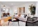 Inviting living room with wood floors, an area rug, gray sofa, and adjacent dining area at 4201 Shoshone St, Denver, CO 80211