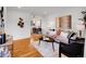Bright living room featuring hardwood floors, a comfortable sofa, and stylish decor at 4201 Shoshone St, Denver, CO 80211