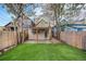 Fenced backyard with artificial turf, porch, patio and alley access at 1020 Kalamath St, Denver, CO 80204
