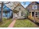 Charming home with unique detailing and a cozy front porch, surrounded by a well-maintained lawn at 1020 Kalamath St, Denver, CO 80204