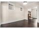 Bright living room with dark hardwood flooring and detailed woodwork around windows and entryway at 1020 Kalamath St, Denver, CO 80204