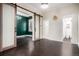 Spacious living room with hardwood flooring, flowing into the adjacent room with sliding barn doors at 1020 Kalamath St, Denver, CO 80204