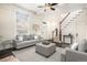 The living room features a neutral rug, gray furniture, a staircase and great natural light at 1020 Kalamath St, Denver, CO 80204