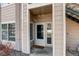 Exterior entryway featuring a storm door, neutral siding, and a cozy welcome mat at 1016 Opal St # 102, Broomfield, CO 80020
