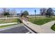 Charming exterior view featuring a pedestrian bridge, landscaping and convenient parking at 1016 Opal St # 102, Broomfield, CO 80020