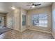 Bright room featuring tile flooring, a ceiling fan, multiple windows, and neutral paint at 1016 Opal St # 102, Broomfield, CO 80020
