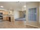 Open-concept kitchen and living room with tile flooring, stainless steel appliances, and natural light at 1016 Opal St # 102, Broomfield, CO 80020