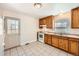 Traditional kitchen features wood cabinets, white appliances, and tile floors, blending function with classic style at 1480 S Osceola St, Denver, CO 80219