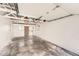 Unfinished basement with concrete floor, white walls, windows, and an exterior door at 1480 S Osceola St, Denver, CO 80219