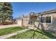 Quaint home featuring a well-kept lawn, a detached garage, and inviting curb appeal, ideal for comfortable living at 1480 S Osceola St, Denver, CO 80219