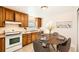 Cozy eat-in kitchen with wooden cabinets, tile floors, and modern appliances, blending functionality with charm at 1480 S Osceola St, Denver, CO 80219