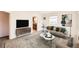 Bright living room featuring contemporary furnishings, lots of natural light, and open access to the kitchen at 1480 S Osceola St, Denver, CO 80219