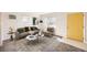 Sunlit living room featuring stylish decor, large windows, and a vibrant yellow door, creating a welcoming atmosphere at 1480 S Osceola St, Denver, CO 80219