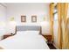 Bright bedroom featuring hardwood floors, warm lighting, and coordinated curtains at 7991 Stuart St, Westminster, CO 80030
