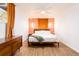 Bright bedroom featuring hardwood floors, a ceiling fan, and a unique accent wall at 7991 Stuart St, Westminster, CO 80030