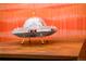 Fun decor piece: a miniature mirror-tiled UFO on a wood table at 7991 Stuart St, Westminster, CO 80030