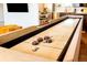 Close-up of the shuffleboard table, inviting entertainment and fun in this home at 7991 Stuart St, Westminster, CO 80030