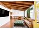 Bright living room with hardwood floors, beamed ceilings, and a comfortable seating area at 7991 Stuart St, Westminster, CO 80030