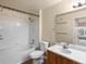Bright bathroom featuring a tiled shower-tub, single sink vanity, and modern fixtures at 4747 S Balsam Way # 104, Littleton, CO 80123