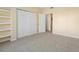 Bedroom featuring carpeted floors, a closet, and a doorway to another room at 4747 S Balsam Way # 104, Littleton, CO 80123