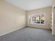 Bright bedroom with neutral tones, plush carpet, and a large window offering neighborhood views at 4747 S Balsam Way # 104, Littleton, CO 80123