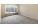 Bright bedroom with neutral tones, plush carpet, and a large window at 4747 S Balsam Way # 104, Littleton, CO 80123